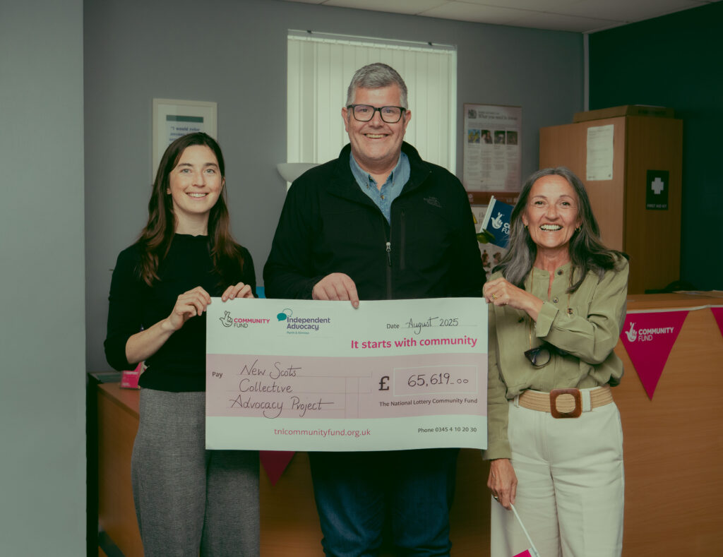 Our New Scot Co-ordinator, Beccy (left), Head of Finance, Andy (middle), and CEO, Julie (right) pictured with the funding from the National Lottery for IAPK's New Scot Collective Advocacy Group.